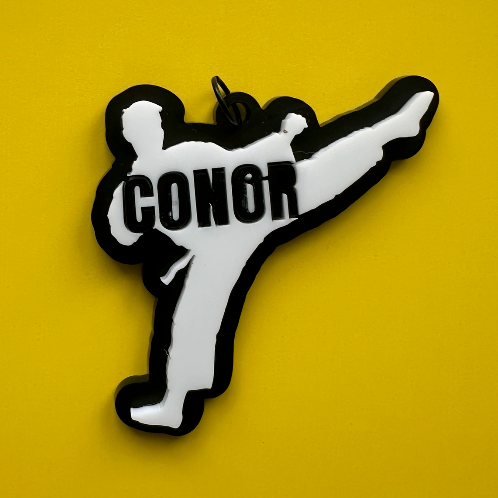 Kick into style! Personalized acrylic bag tag shaped like a martial-arts silhouette β perfect for karate, taekwondo, or sports bags.