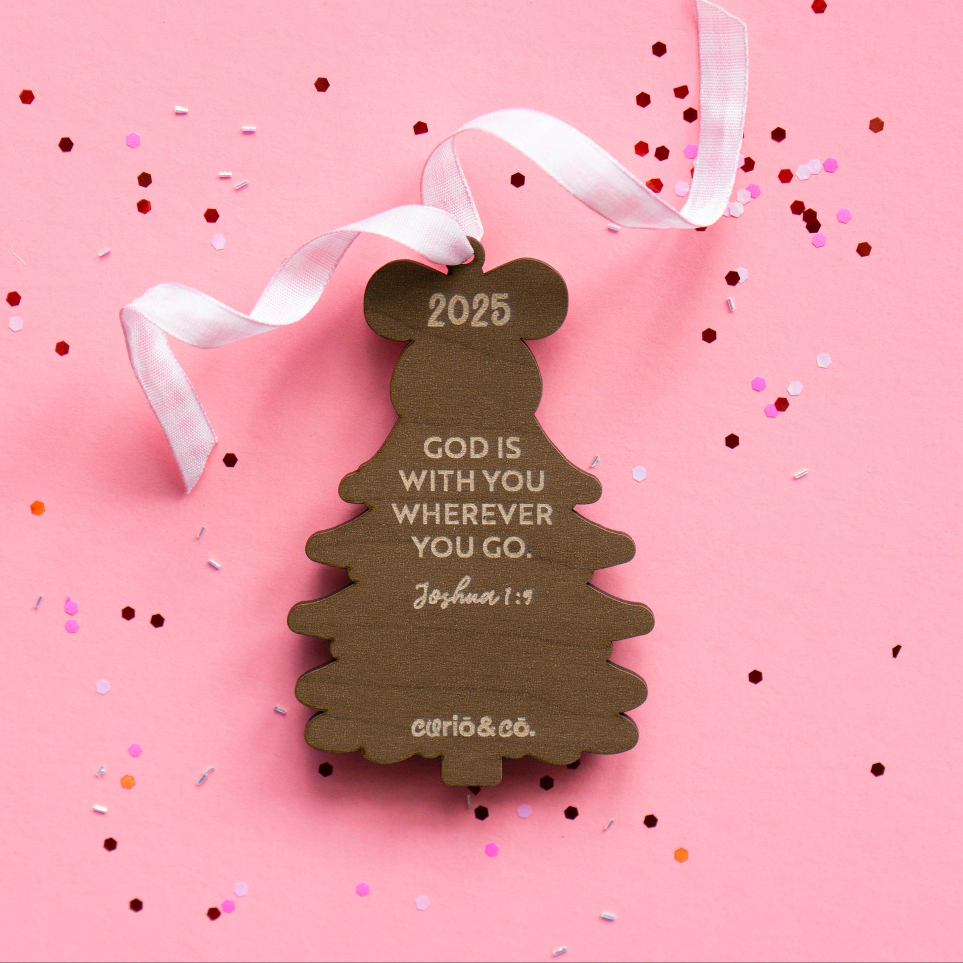 Back of wood tree ornament showing 2025 and engraved Bible verse Joshua 1:9.