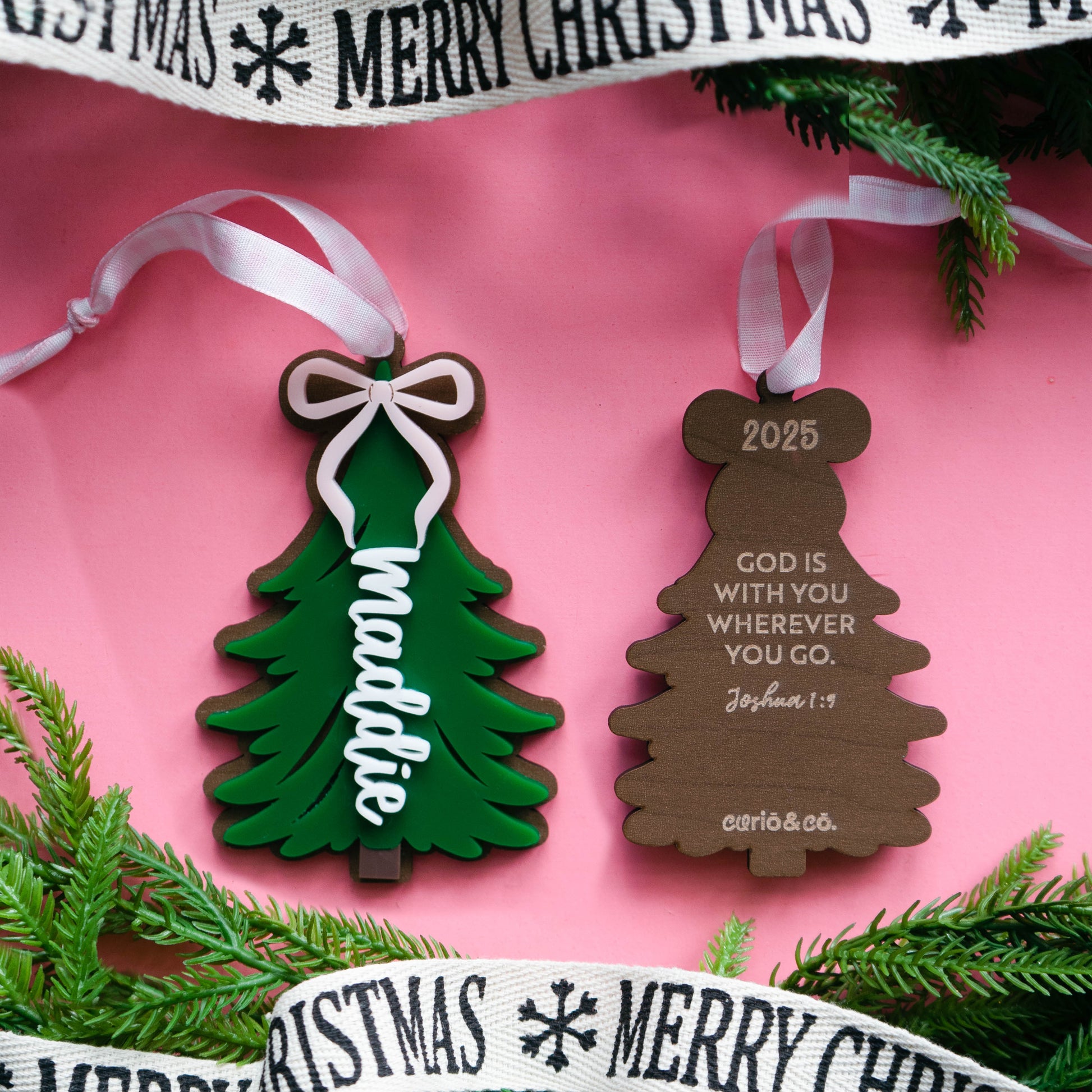 Close-up of layered acrylic Christmas ornament with ribbon front and back.