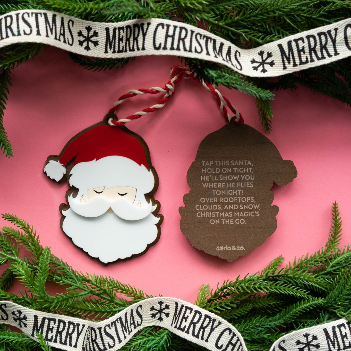 Acrylic Santa ornament with engraved rhyme on wood back on pink background with confetti — Curio & Co.”