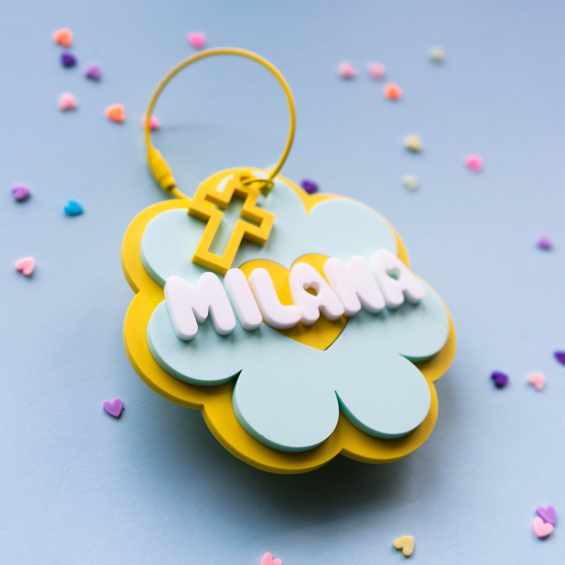 Colorful flower keychain with custom name on a blue background