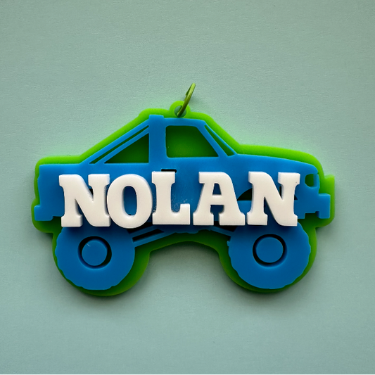 Built for bold kids who love trucks! Fun layered acrylic tag with your child’s name — perfect for backpacks and travel bags.